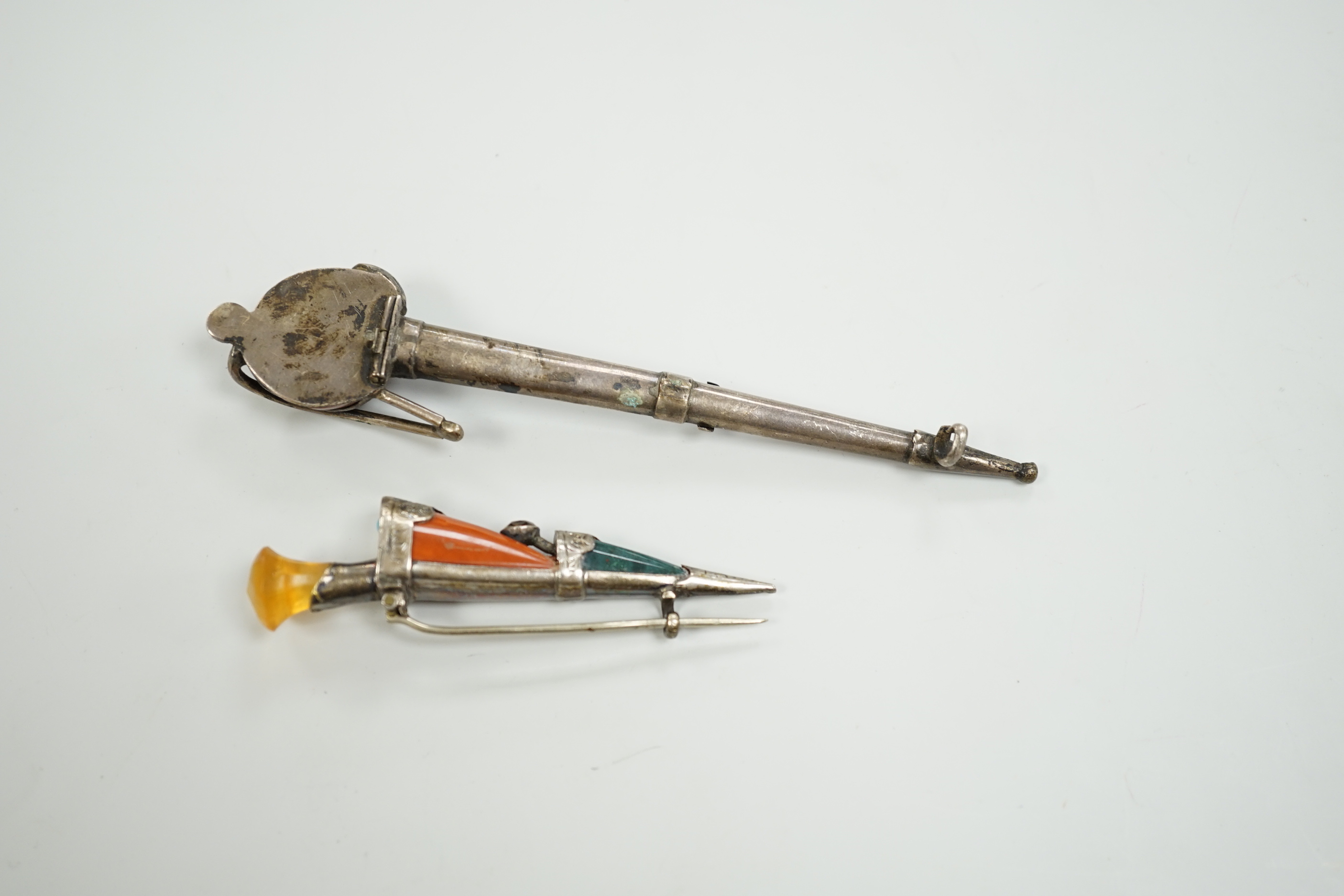 Two early 20th century white metal and Scottish hardstones set dagger or sword brooches, largest 11.6cm.